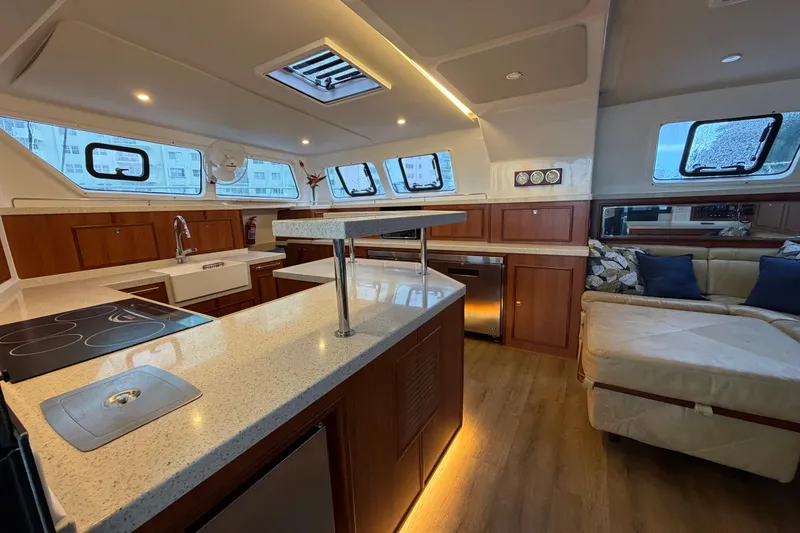Slide: The Image of Luxurious interior of 2023 Royal Cape Catamarans Majestic 530 with modern kitchen and seating area. - 115