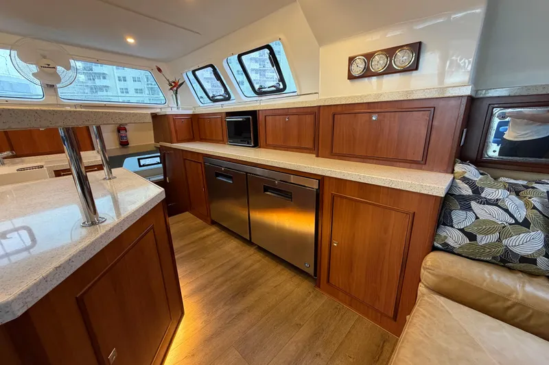 Slide: The Image of Luxurious 2023 Royal Cape Catamarans Majestic 530 interior with modern kitchen and wood cabinetry. - 116