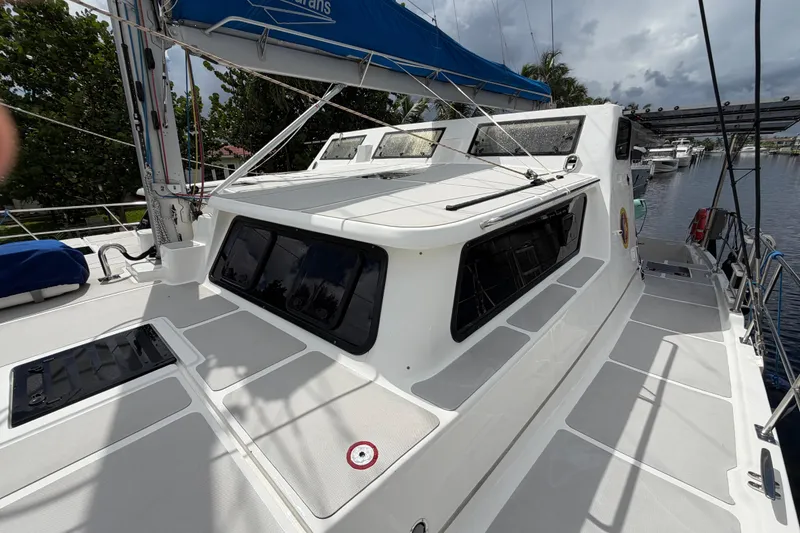 Slide: The Image of 2023 Royal Cape Catamarans Majestic 530 on a calm waterway, showcasing sleek design and spacious deck. - 16