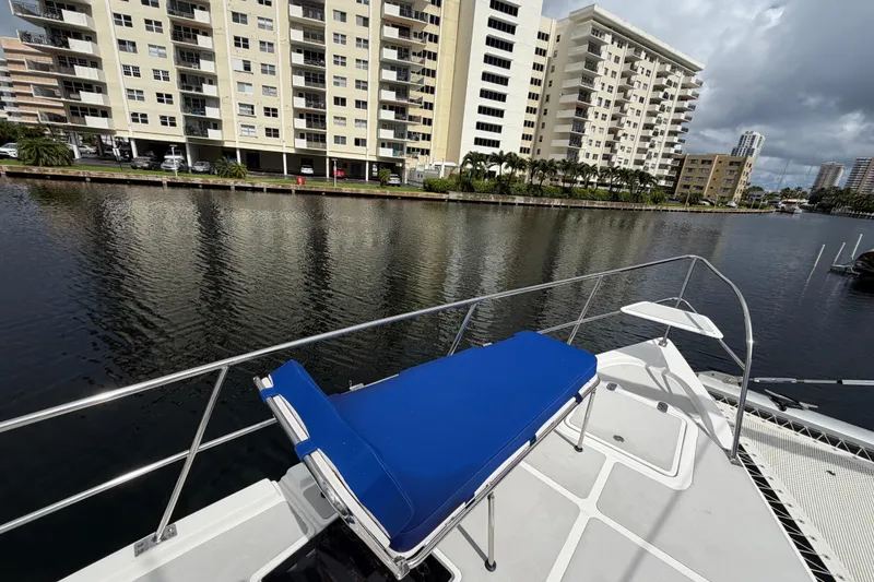 Slide: The Image of 2023 Royal Cape Catamarans Majestic 530 docked near waterfront apartments. - 17
