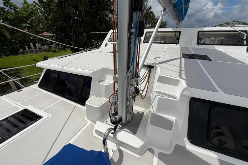 Slide: The Image of 2023 Royal Cape Catamarans Majestic 530 deck with rigging and windows, under a cloudy sky. - 18