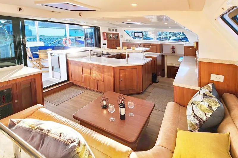 Slide: The Image of Luxurious interior of 2023 Royal Cape Catamarans Majestic 530 with modern kitchen and seating area. - 2