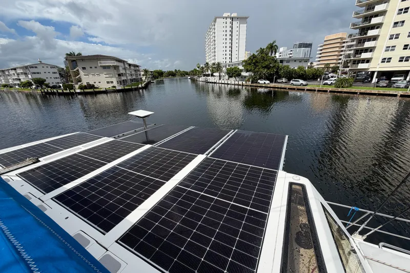 Slide: The Image of 2023 Royal Cape Catamarans Majestic 530 with solar panels on a scenic waterfront. - 22