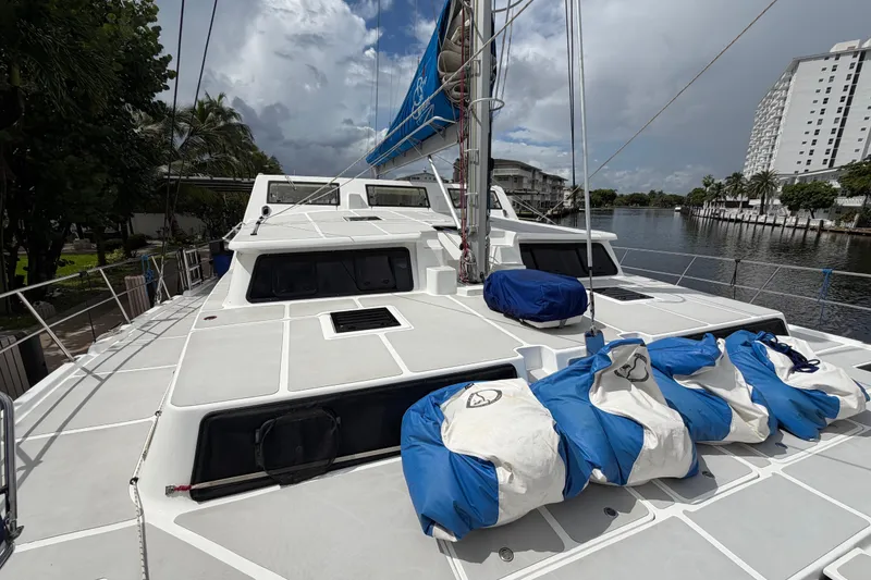 Slide: The Image of 2023 Royal Cape Catamarans Majestic 530 on a calm waterway, featuring a spacious deck. - 28