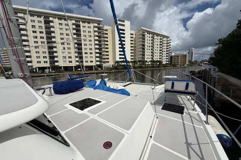Slide: The Image of 2023 Royal Cape Catamarans Majestic 530 docked near waterfront buildings under cloudy sky. - 32