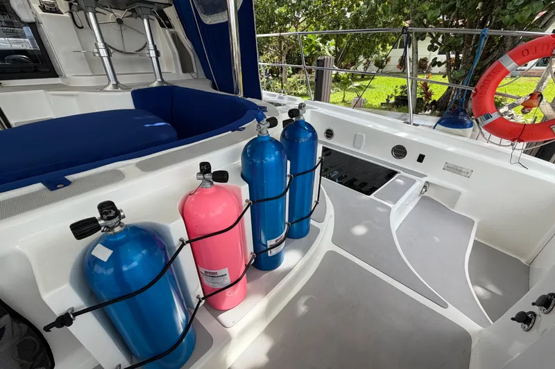 Slide: The Image of 2023 Royal Cape Catamarans Majestic 530 deck with scuba tanks and safety equipment. - 37