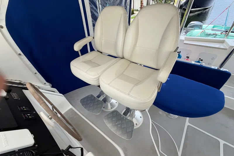Slide: The Image of Captain's chairs and helm on 2023 Royal Cape Catamarans Majestic 530 yacht. - 41