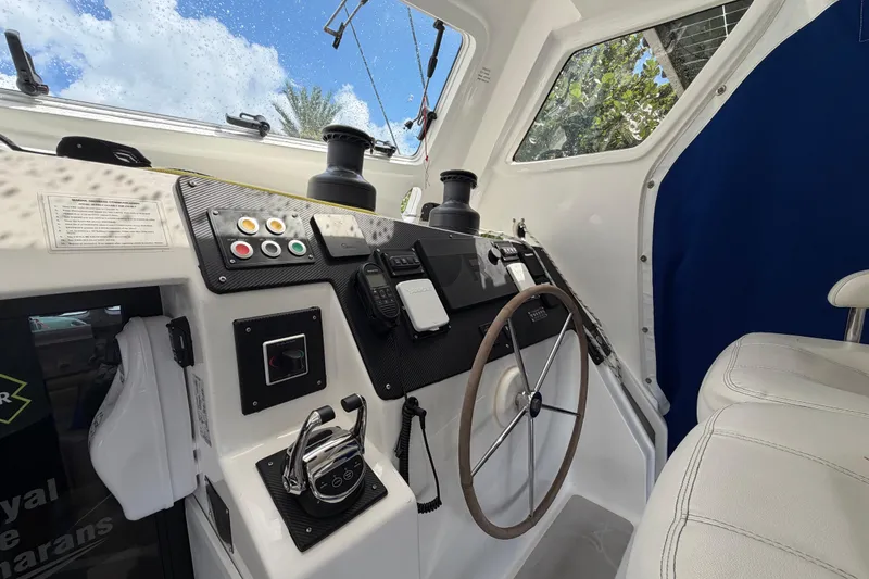 Slide: The Image of Interior helm of 2023 Royal Cape Catamarans Majestic 530, featuring modern controls and steering wheel. - 43