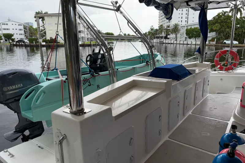 Slide: The Image of 2023 Royal Cape Catamarans Majestic 530 deck with Yamaha motor and docked tender. - 49