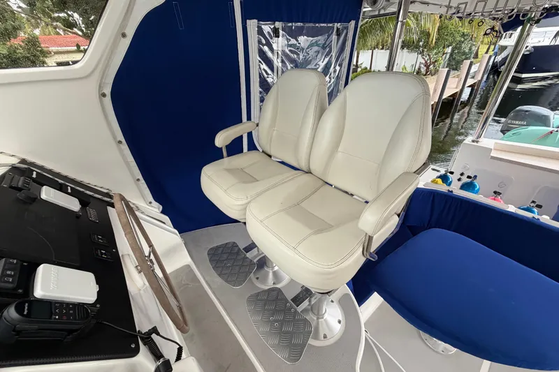 Slide: The Image of Helm seating area on 2023 Royal Cape Catamarans Majestic 530 with dual white captain chairs. - 52