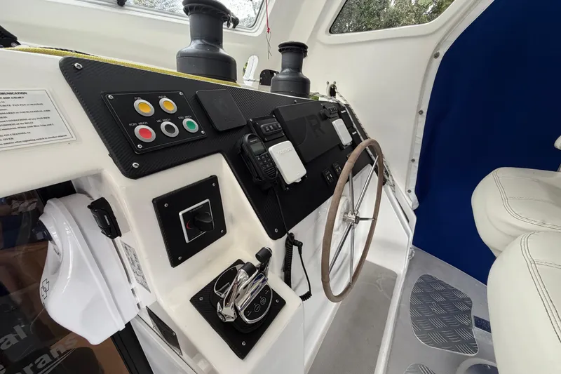 Slide: The Image of Helm station of 2023 Royal Cape Catamarans Majestic 530 with controls and steering wheel. - 55