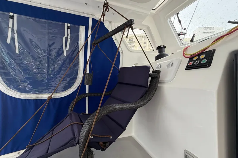 Slide: The Image of Hammock chair on 2023 Royal Cape Catamarans Majestic 530, featuring blue and white interior. - 57