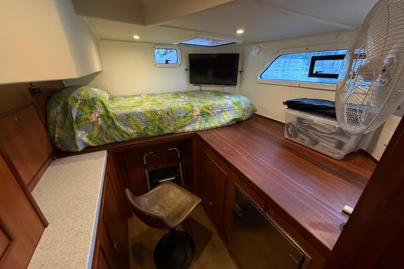 Slide: The Image of 2023 Royal Cape Catamarans Majestic 530 cabin with bed, TV, and fan. - 65
