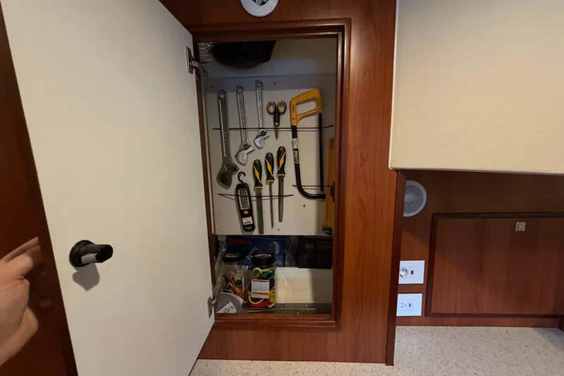 Slide: The Image of Tool storage cabinet on 2023 Royal Cape Catamarans Majestic 530, featuring organized tools and equipment. - 66