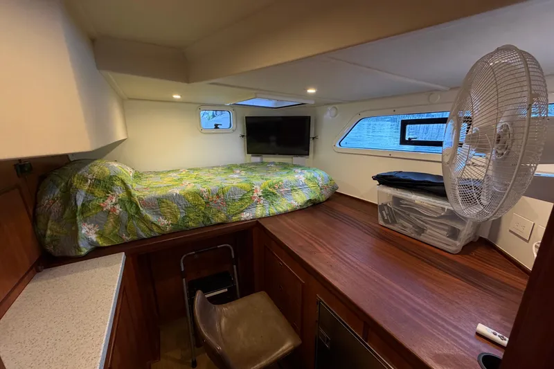 Slide: The Image of 2023 Royal Cape Catamarans Majestic 530 cabin with bed, fan, and TV. - 67