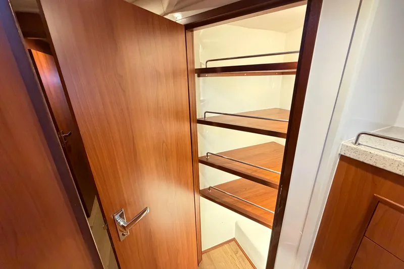 Slide: The Image of Wooden pantry shelves inside the 2023 Royal Cape Catamarans Majestic 530. - 69