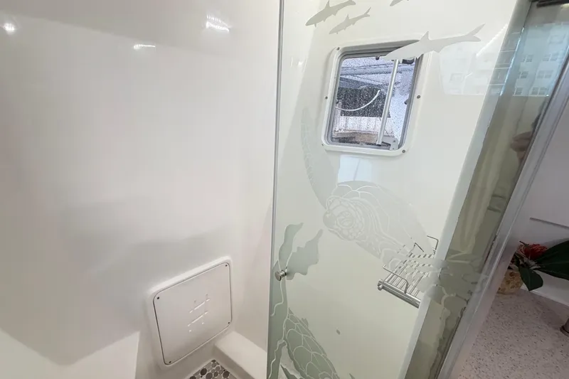 Slide: The Image of Interior of 2023 Royal Cape Catamarans Majestic 530, featuring a stylish bathroom with etched glass. - 72