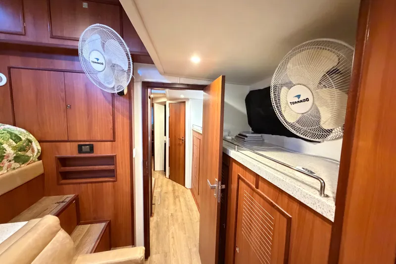 Slide: The Image of Interior of 2023 Royal Cape Catamarans Majestic 530 with wood paneling and fans. - 78