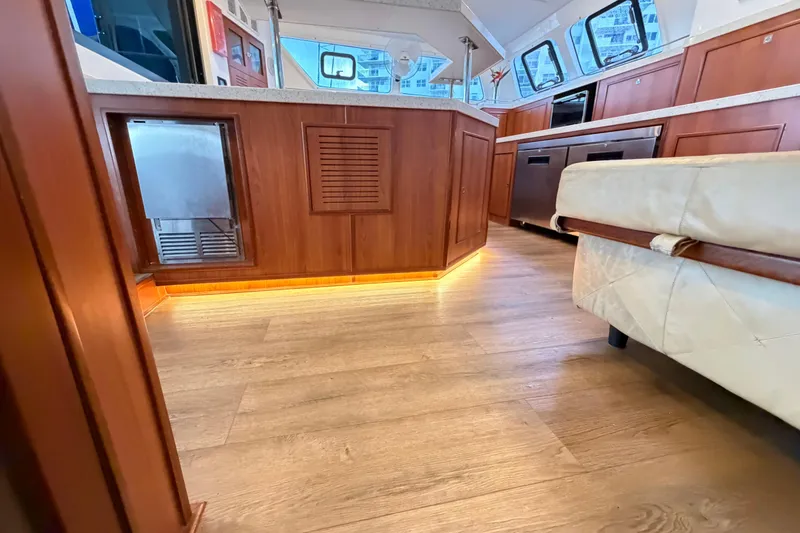 Slide: The Image of Luxurious interior of 2023 Royal Cape Catamarans Majestic 530, featuring wood flooring and modern kitchen. - 83