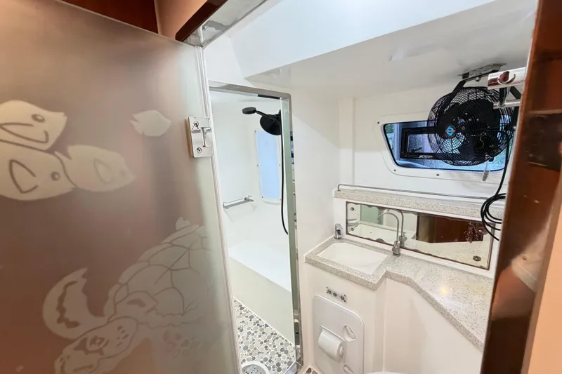 Slide: The Image of Bathroom interior of 2023 Royal Cape Catamarans Majestic 530, featuring modern fixtures and nautical decor. - 84