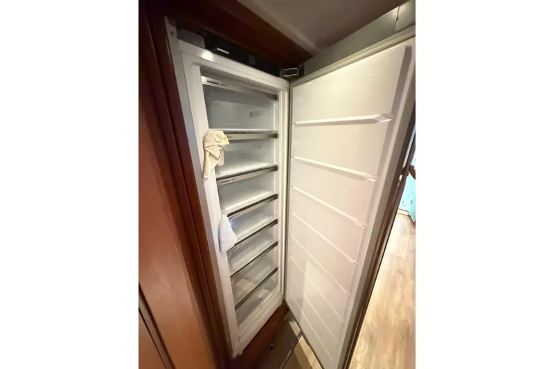 Slide: The Image of Open refrigerator inside 2023 Royal Cape Catamarans Majestic 530, showcasing spacious interior shelves. - 87