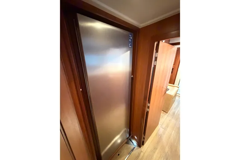 Slide: The Image of Interior view of 2023 Royal Cape Catamarans Majestic 530, featuring sleek wooden cabinetry. - 88