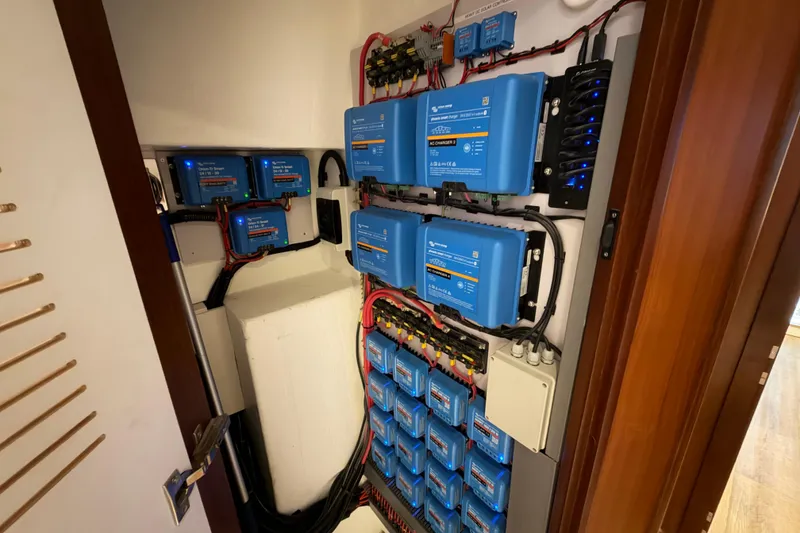 Slide: The Image of Electrical system of 2023 Royal Cape Catamarans Majestic 530, featuring blue power inverters and wiring. - 89
