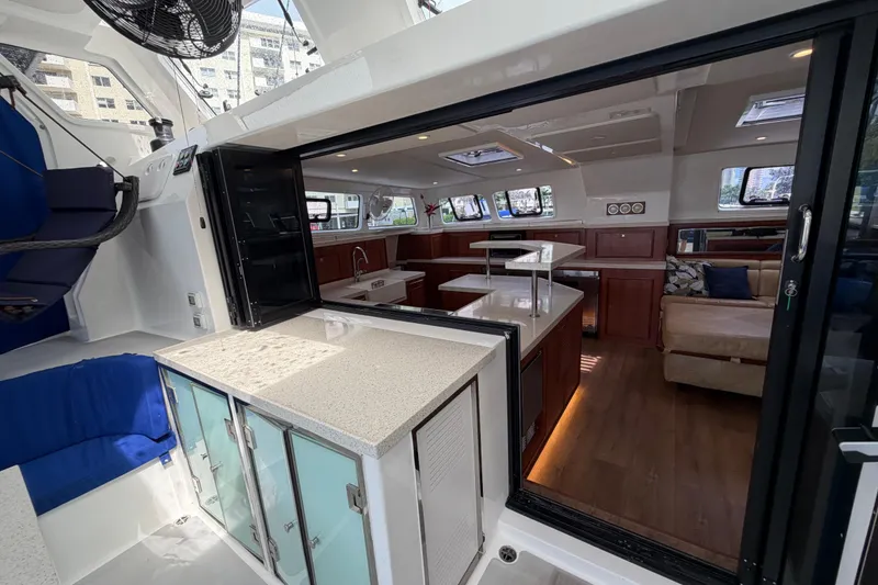 Slide: The Image of Luxurious interior of 2023 Royal Cape Catamarans Majestic 530, featuring modern kitchen and seating area. - 9