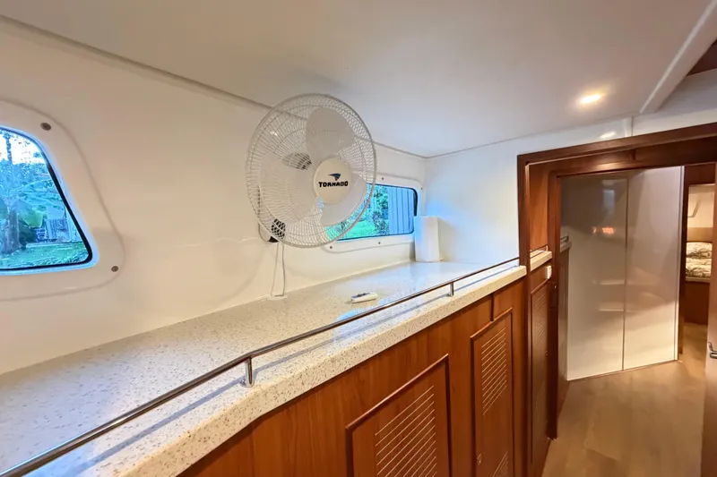 Slide: The Image of Interior of 2023 Royal Cape Catamarans Majestic 530 with fan and wooden cabinetry. - 90