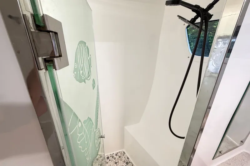 Slide: The Image of Shower area in 2023 Royal Cape Catamarans Majestic 530 with glass door and modern fixtures. - 93