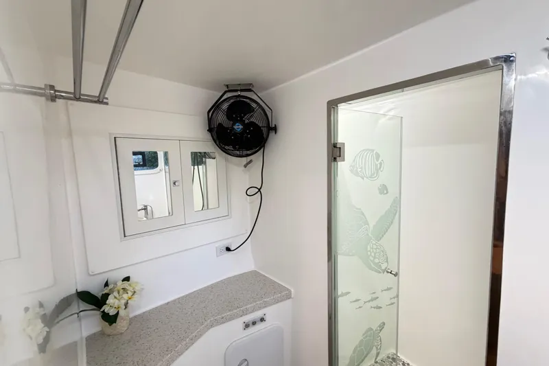 Slide: The Image of Modern bathroom in 2023 Royal Cape Catamarans Majestic 530 with glass shower and fan. - 94