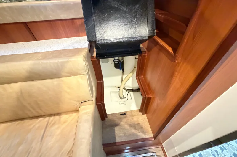 Slide: The Image of Interior view of 2023 Royal Cape Catamarans Majestic 530, featuring wooden cabinetry and seating. - 97