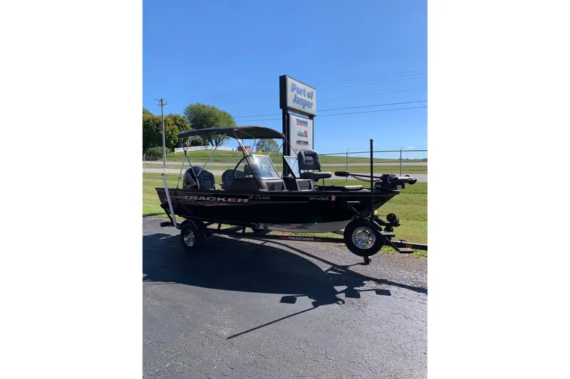 The Image of 2023 Bass Tracker Pro Guide V-16 WT boat on trailer, parked outdoors. - 1