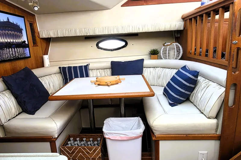 Slide: The Image of Interior of 1990 Californian 48 Cockpit Motor Yacht with cozy seating and nautical decor. - 17