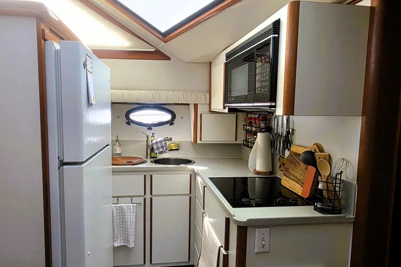 Slide: The Image of 1990 Californian 48 Cockpit Motor Yacht kitchen with modern appliances and compact design. - 18