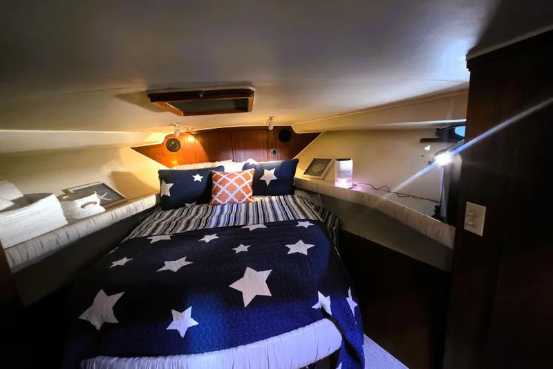 Slide: The Image of Cozy bedroom in 1990 Californian 48 Cockpit Motor Yacht with star-themed bedding. - 22