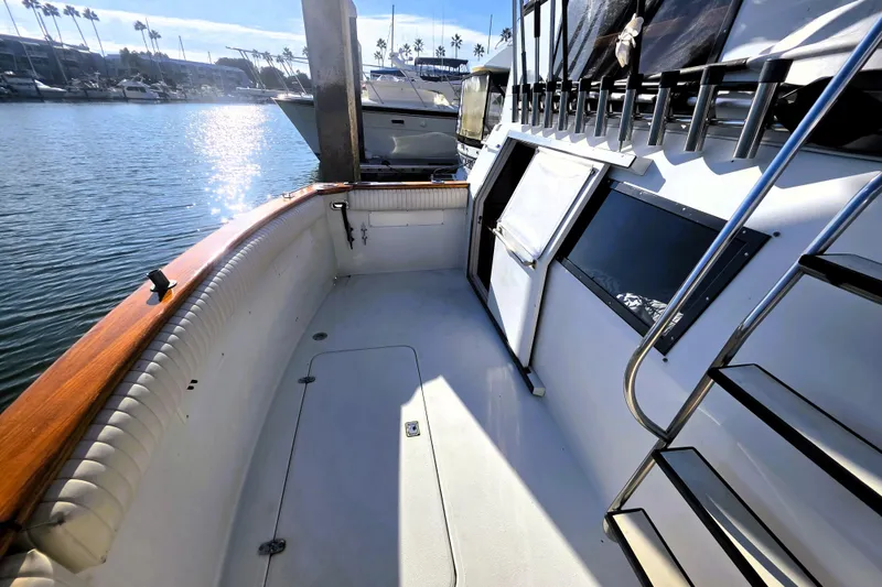 Slide: The Image of 1990 Californian 48 Cockpit Motor Yacht docked, featuring spacious deck and sleek design. - 38