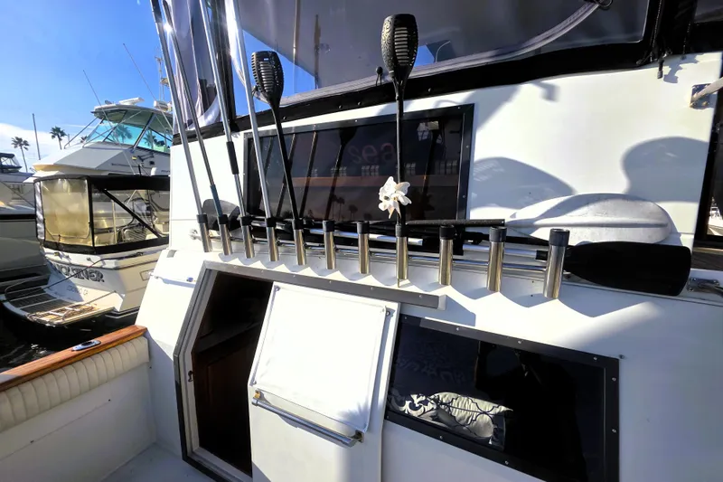 Slide: The Image of 1990 Californian 48 Cockpit Motor Yacht with fishing rod holders and open cabin door. - 39