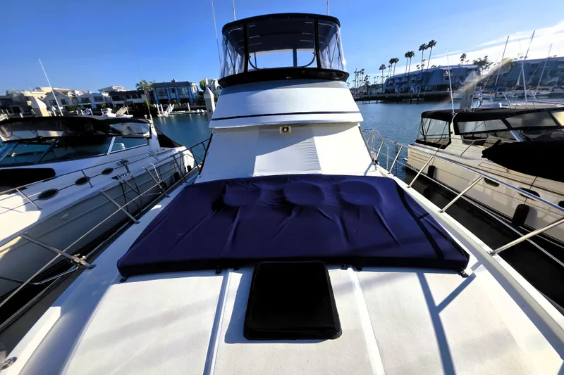 Slide: The Image of 1990 Californian 48 Cockpit Motor Yacht docked in sunny marina setting. - 43