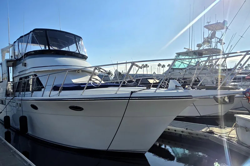 Slide: The Image of 1990 Californian 48 Cockpit Motor Yacht docked at marina under clear blue sky. - 44