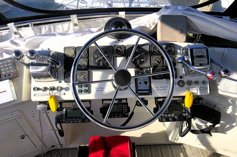 Slide: The Image of Cockpit of 1990 Californian 48 Cockpit Motor Yacht with steering wheel and control panel. - 9