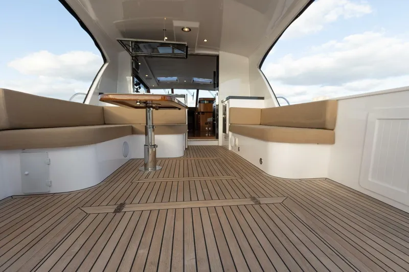 Slide: The Image of Luxurious 2026 Hylas M49 yacht interior with wooden deck and cushioned seating. - 13