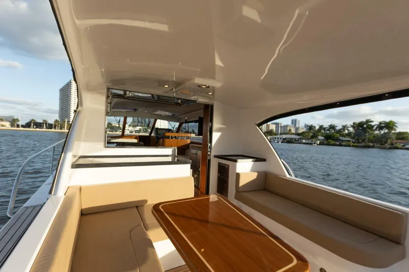 Slide: The Image of Luxurious 2026 Hylas M49 yacht interior with elegant seating and scenic waterfront view. - 15