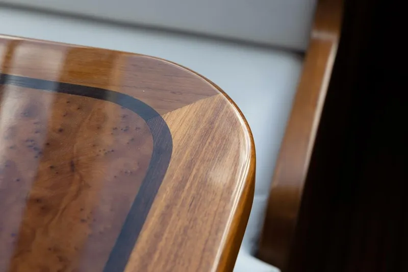 Slide: The Image of Polished wooden table corner on Hylas M49, 2026 model yacht interior. - 16