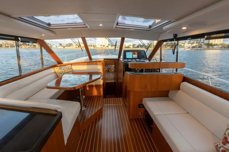 Slide: The Image of Luxurious interior of 2026 Hylas M49 yacht with elegant wood finishes and waterfront view. - 19