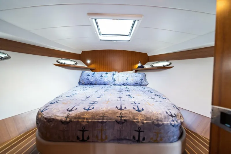 Slide: The Image of Luxurious cabin interior of 2026 Hylas M49 yacht with nautical-themed bedding. - 22
