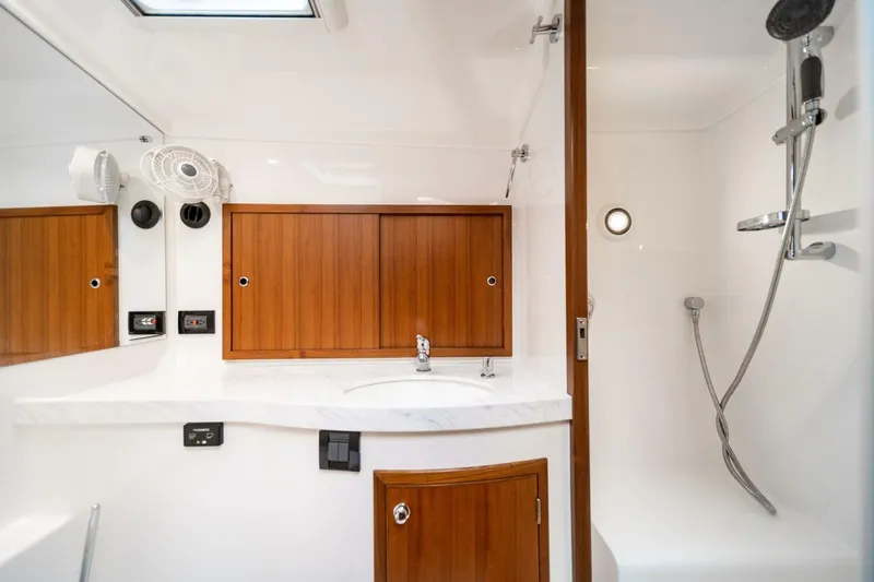 Slide: The Image of Luxurious Hylas M49 2026 yacht bathroom with wooden cabinets and modern shower. - 23