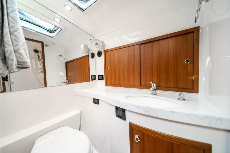 Slide: The Image of Luxurious 2026 Hylas M49 yacht bathroom with wooden cabinets and modern fixtures. - 24