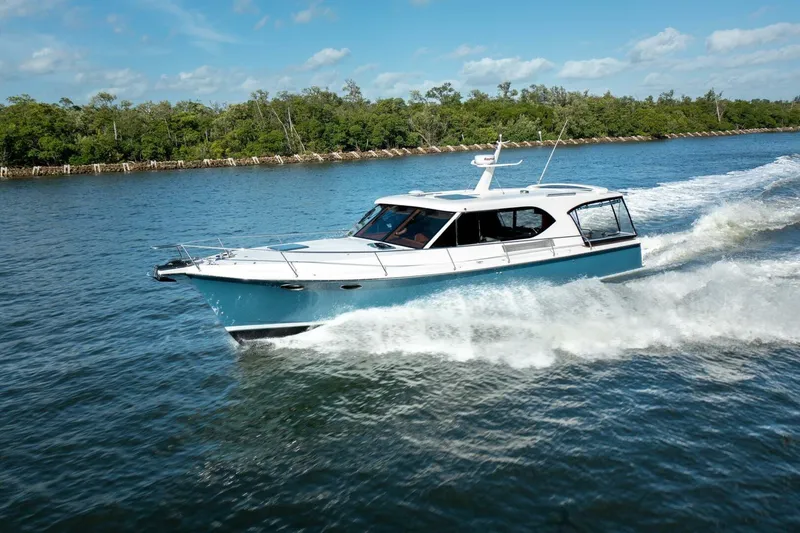 Slide: The Image of 2026 Hylas M49 yacht cruising on a scenic waterway under a clear blue sky. - 3