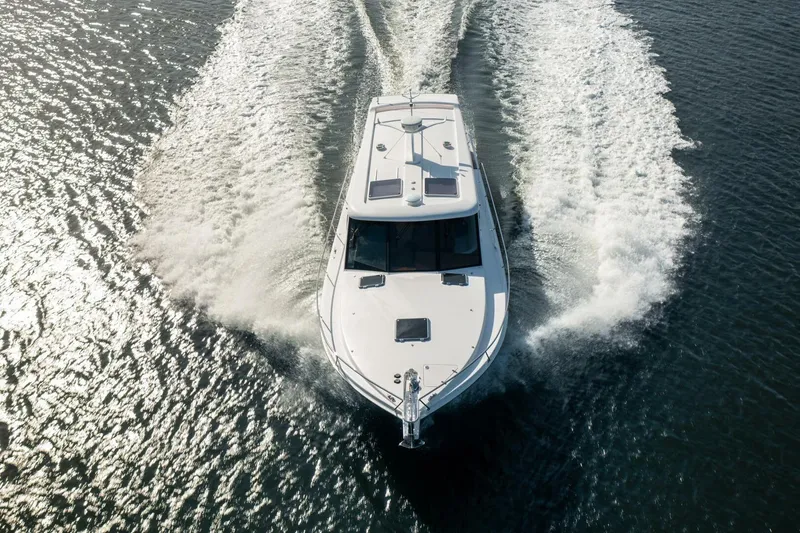 Slide: The Image of 2026 Hylas M49 yacht cruising on open water, aerial view. - 4
